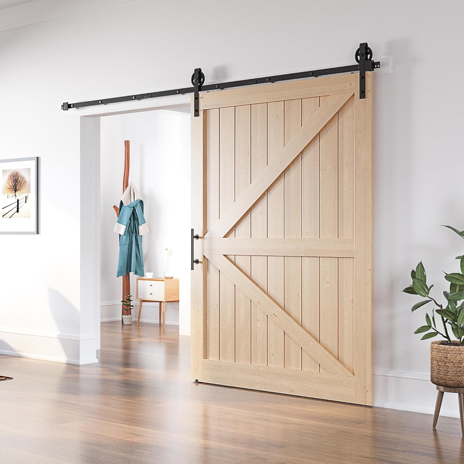 Wooden sliding barn door in a modern interior setting with a plant and furniture.