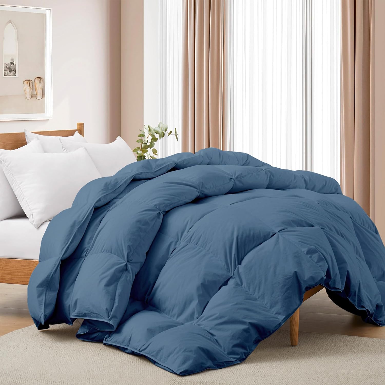 Blue comforter on a bed in a bedroom setting