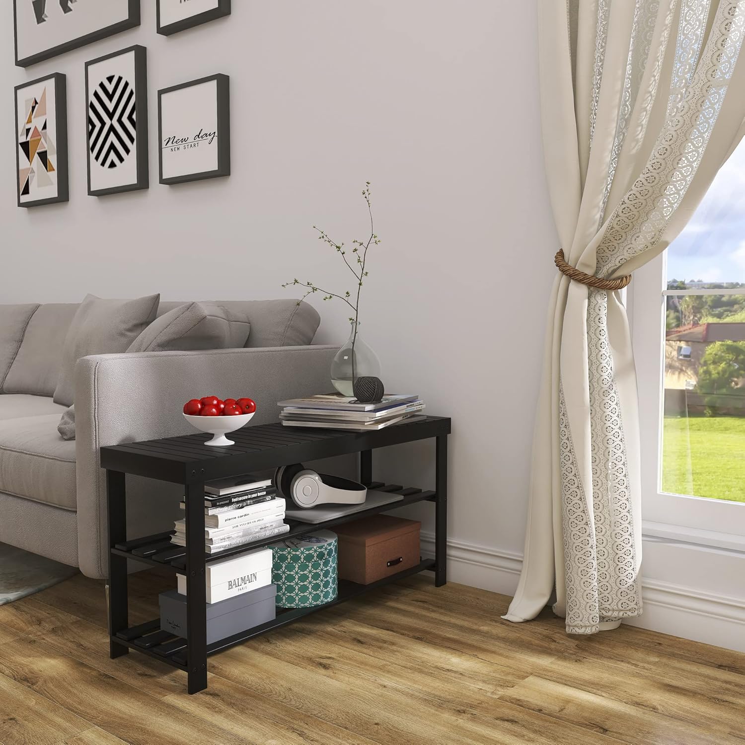 Living room with a black side table, gray sofa, and decorative elements.