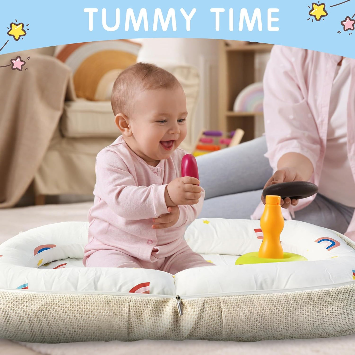 Baby playing with toys on a cushion during tummy time.