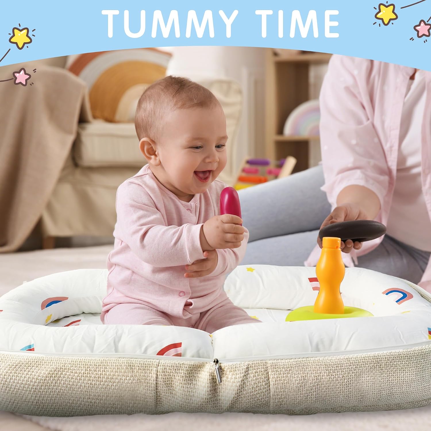 Baby playing with toys on a cushion during tummy time.