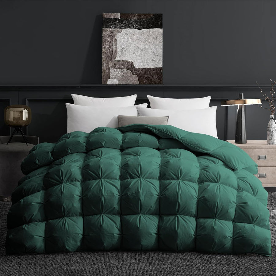 Green quilted comforter on a bed in a bedroom setting with abstract art on the wall.