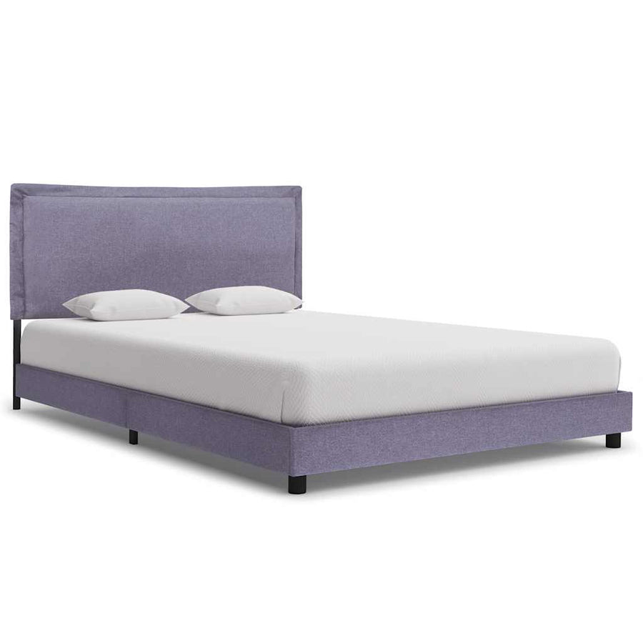 Purple upholstered bed with white mattress and pillows on a white background