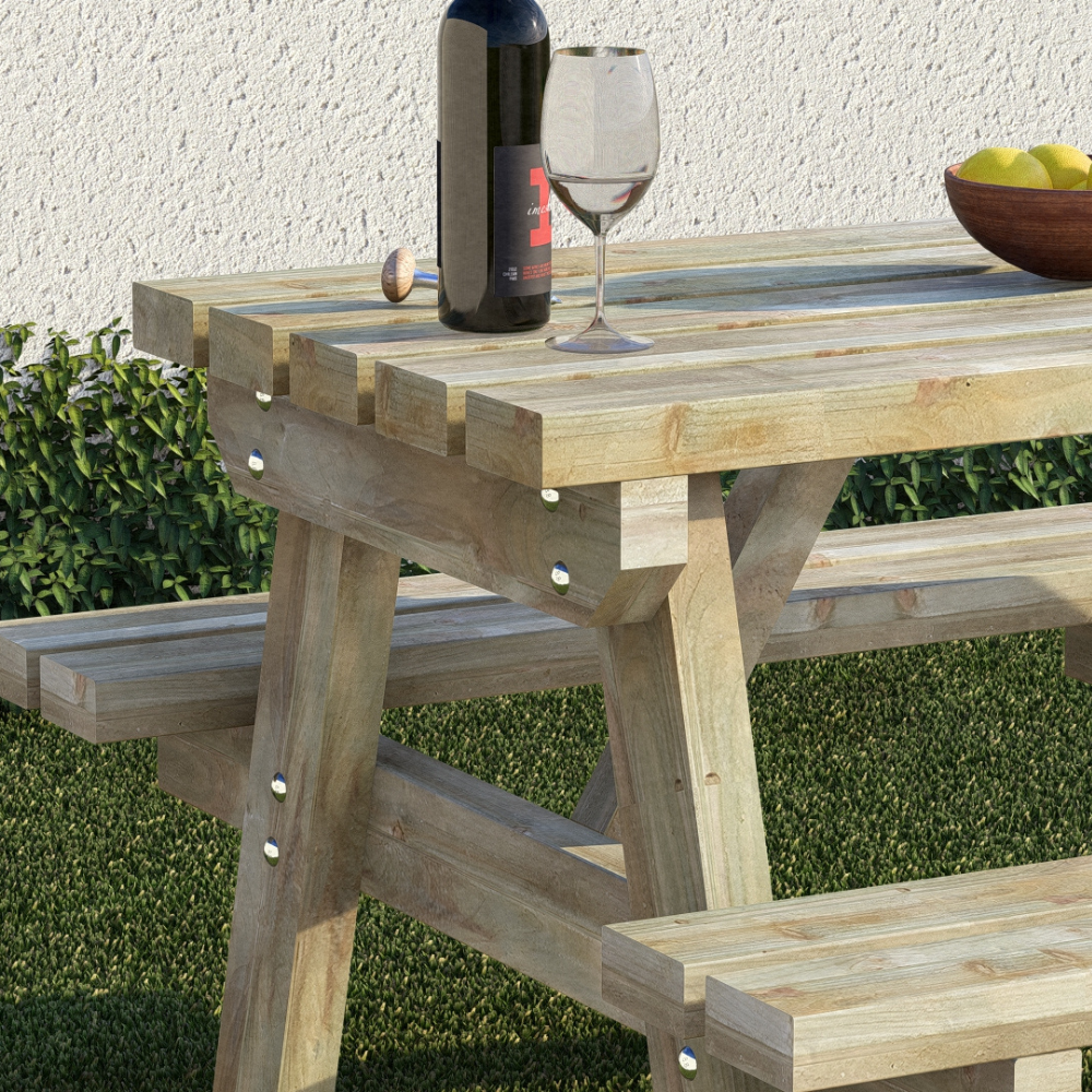 Wooden outdoor table with a bottle, glass, and bowl on top, set against a grassy background.