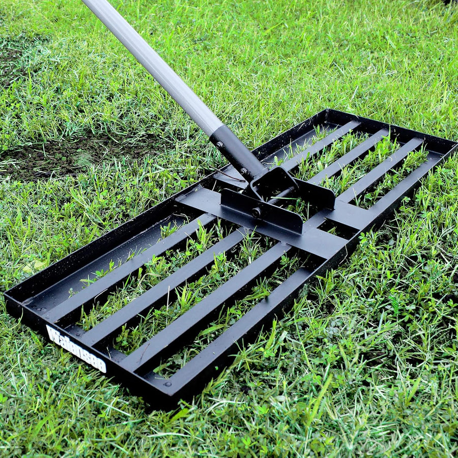 Black lawn rake on grass
