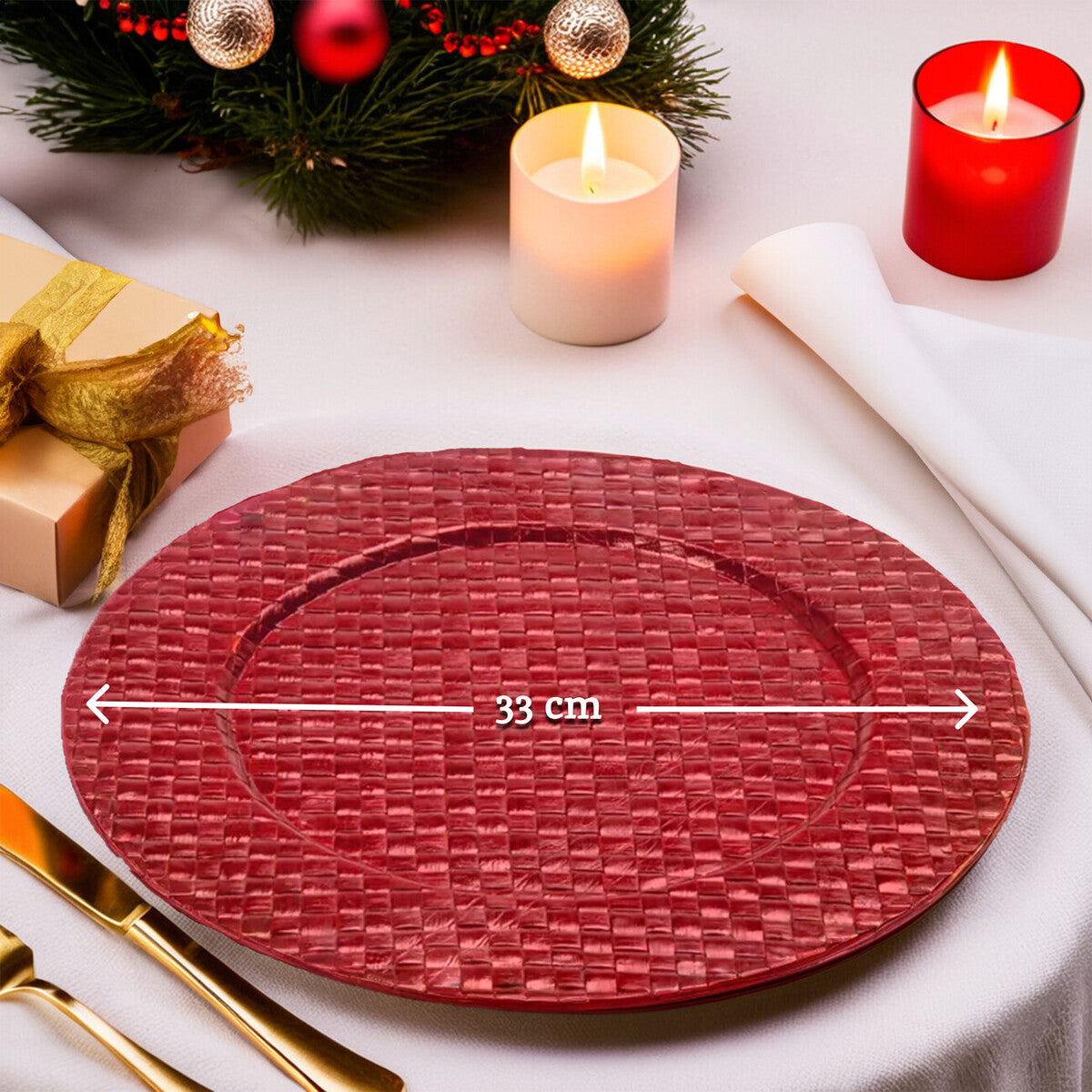 Red woven placemat on a table with candles and Christmas decorations