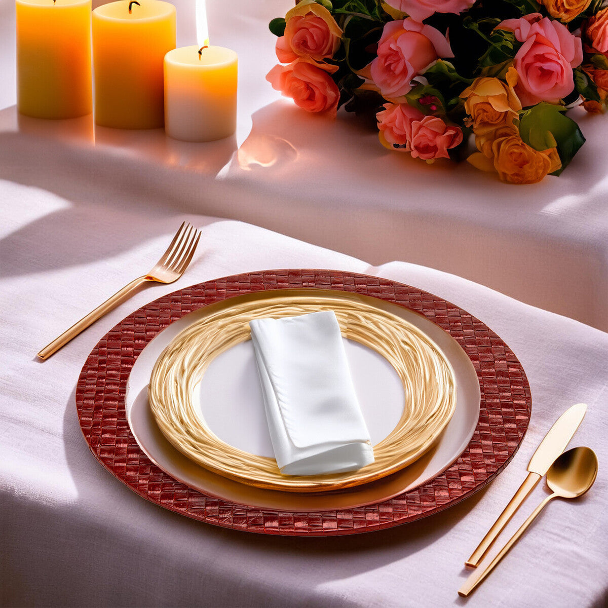 Dining table setting with red woven placemat, gold plates, white napkin, and floral arrangement.