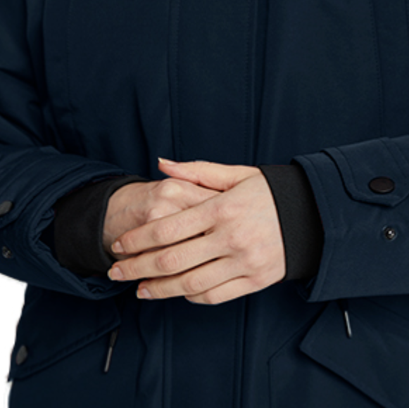 Person wearing a dark blue coat with hands clasped in front