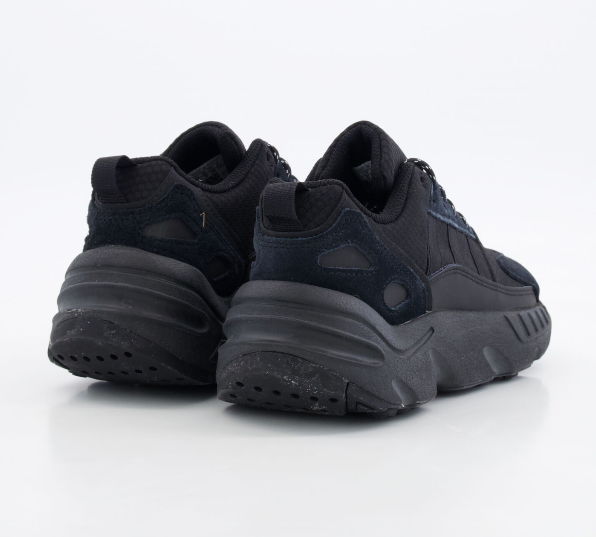 Black sneakers with thick soles on a white background