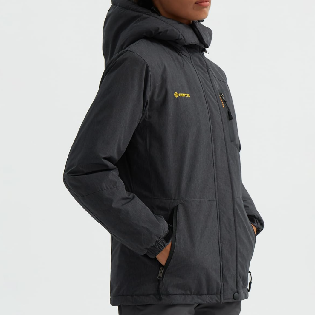 Person wearing a black jacket with a brand logo on a light gray background