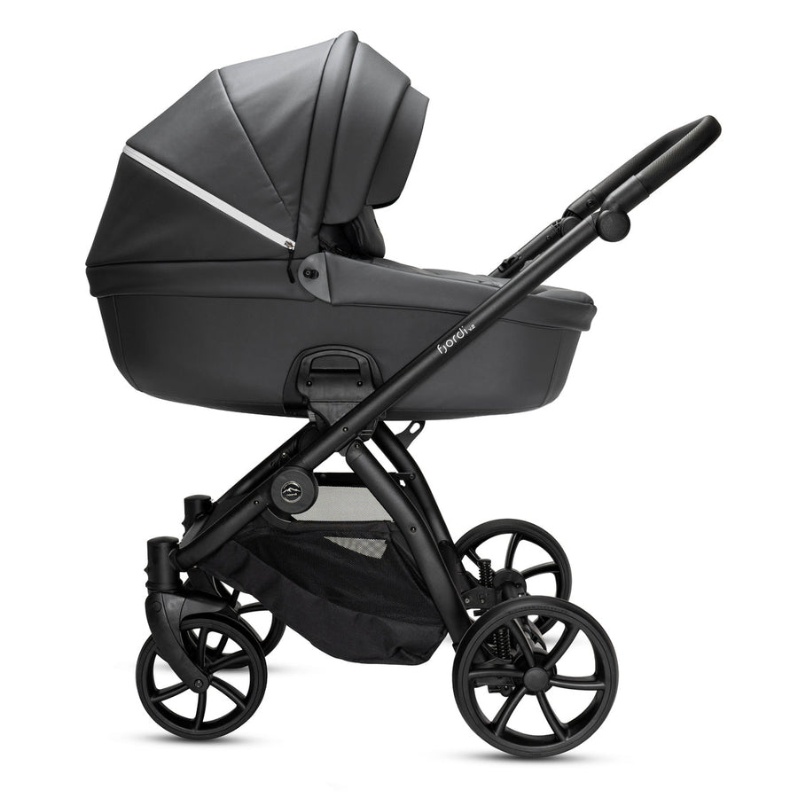 Green and black stroller on a white background