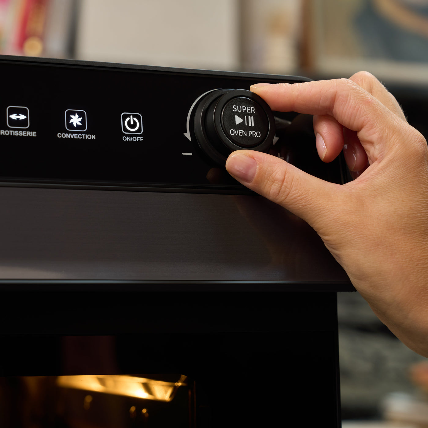 Hand pressing a button on an oven control panel with various icons.