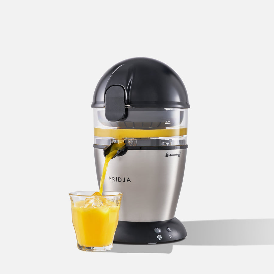 Fridja juicer pouring orange juice into a glass on a white background