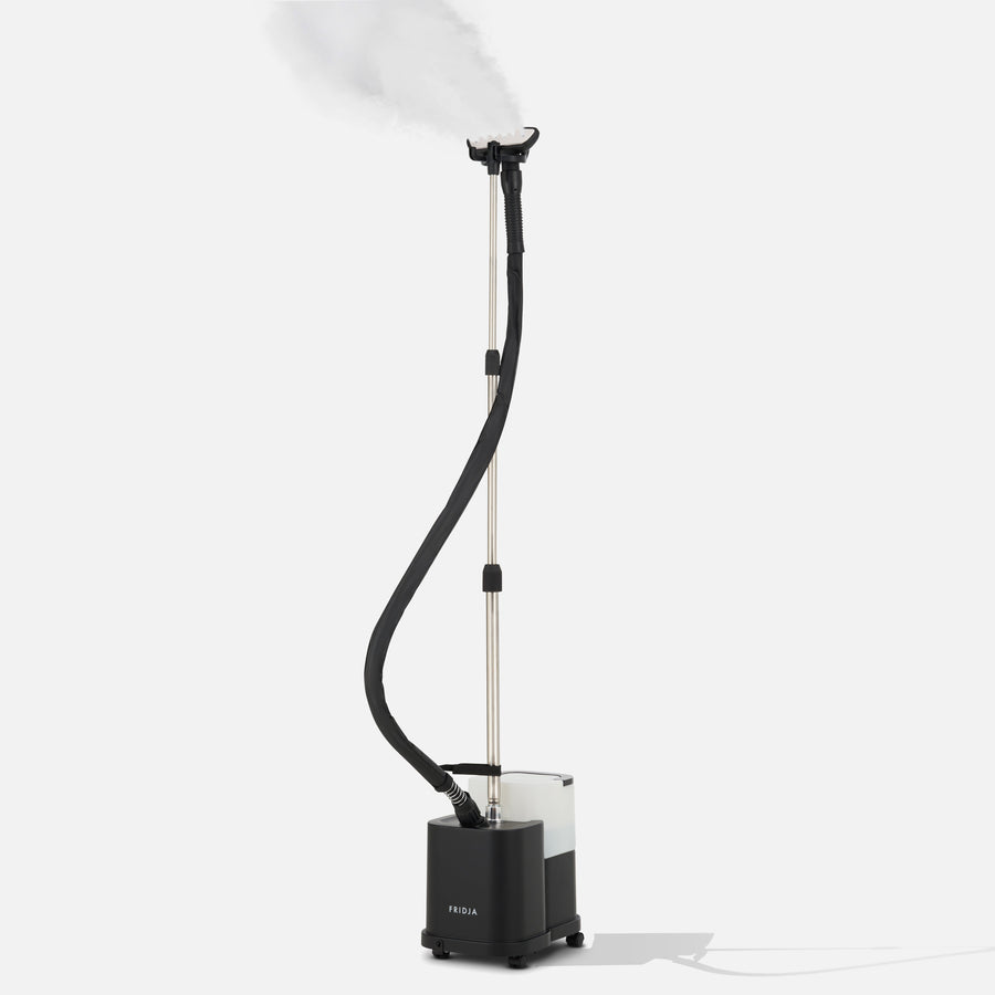 Black garment steamer with a long hose on a white background