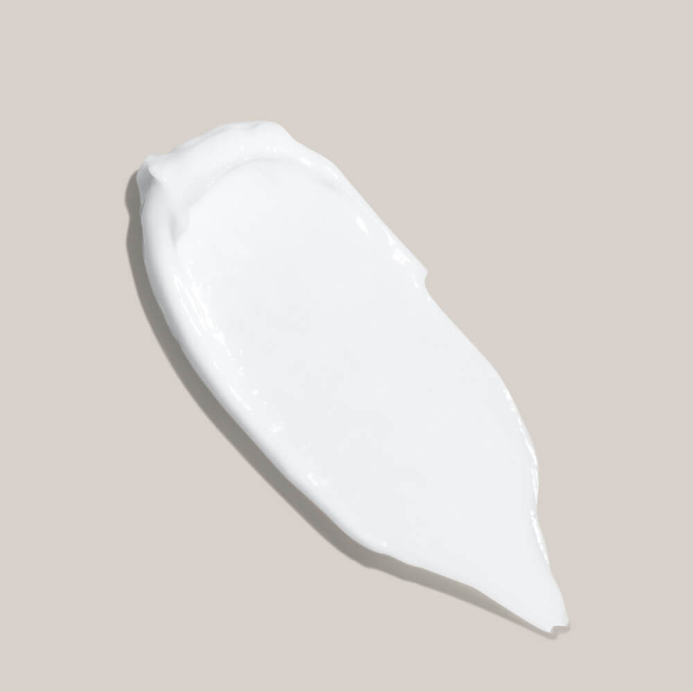 White ceramic teardrop-shaped dish on a beige background