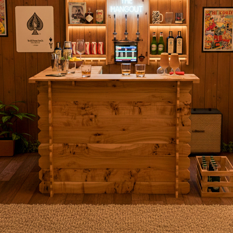 Wooden bar setup with drinks and decor in a cozy room.