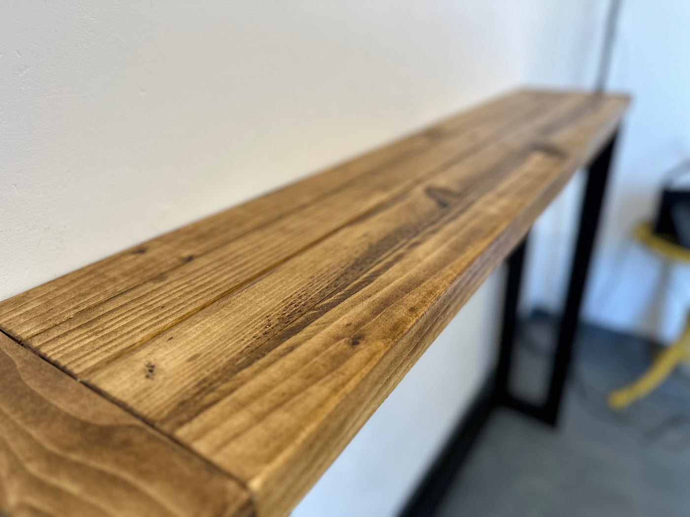 Wooden shelf against a white wall