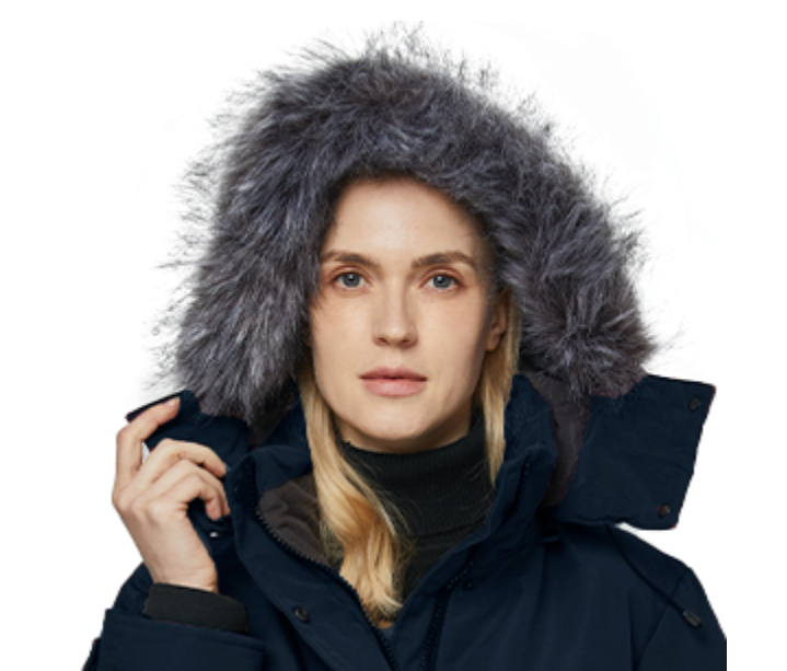 Person wearing a dark blue winter coat with a fur-lined hood on a white background