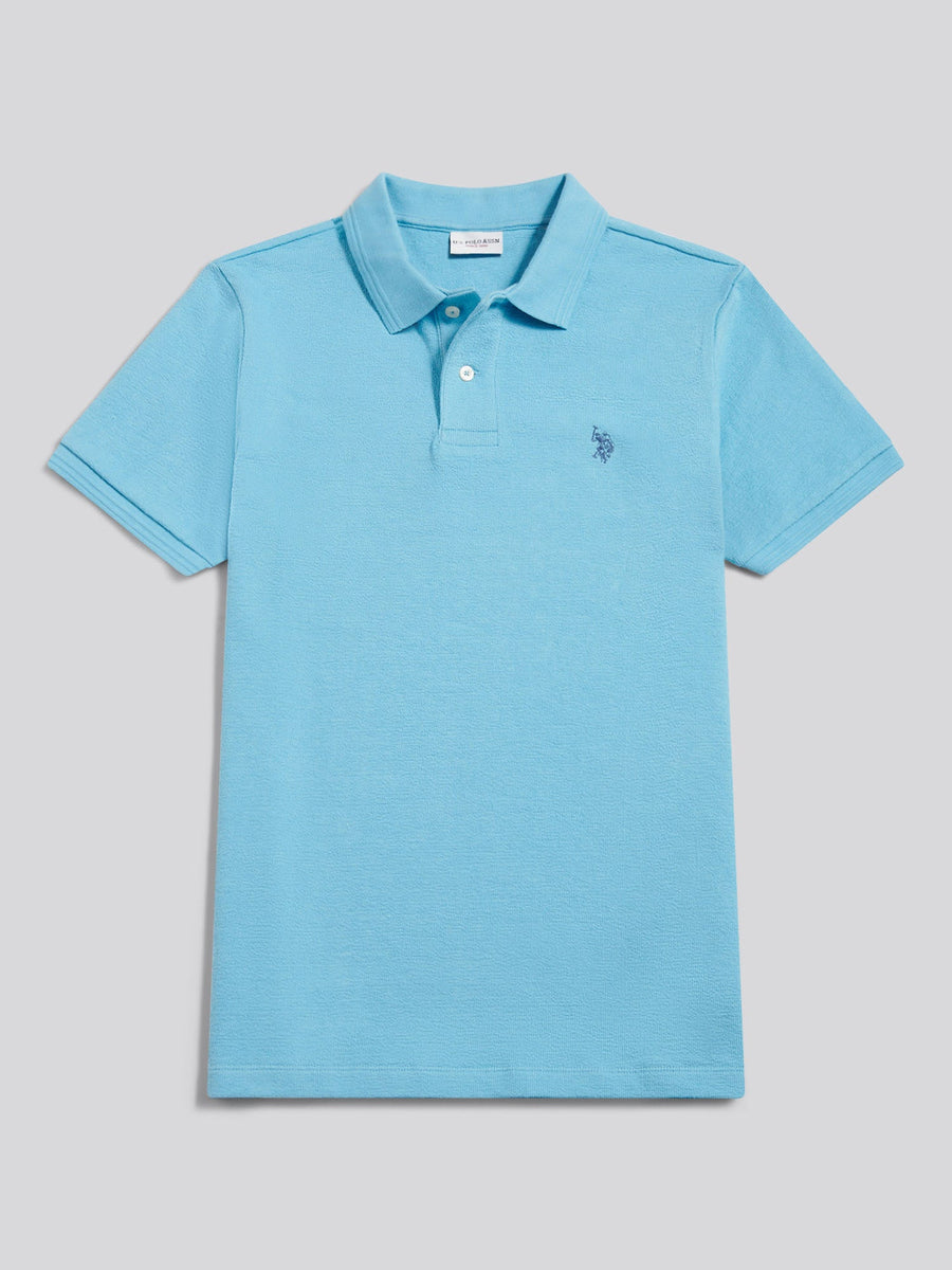 Light blue polo shirt with a small logo on a gray background