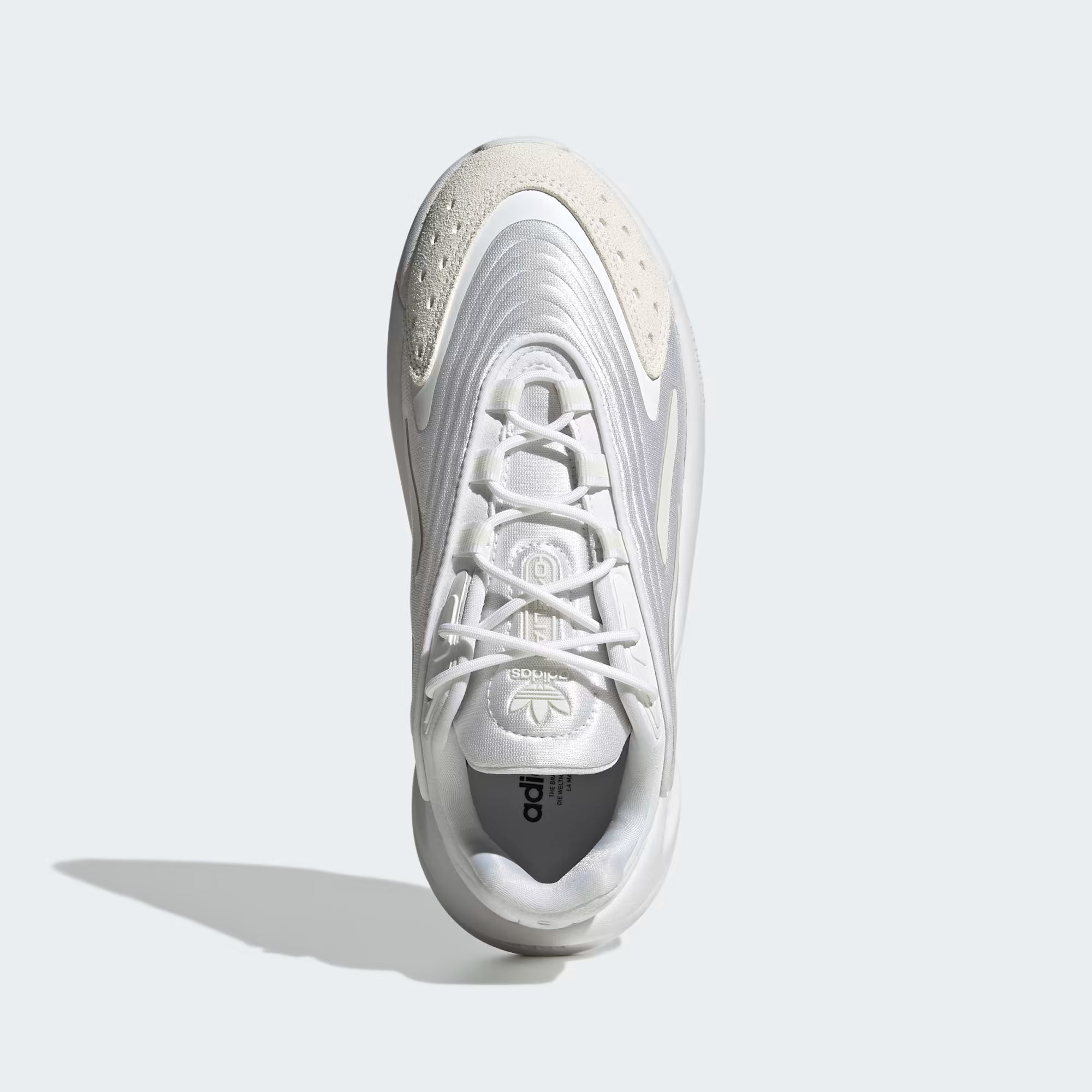 White Adidas sneaker on a light gray background