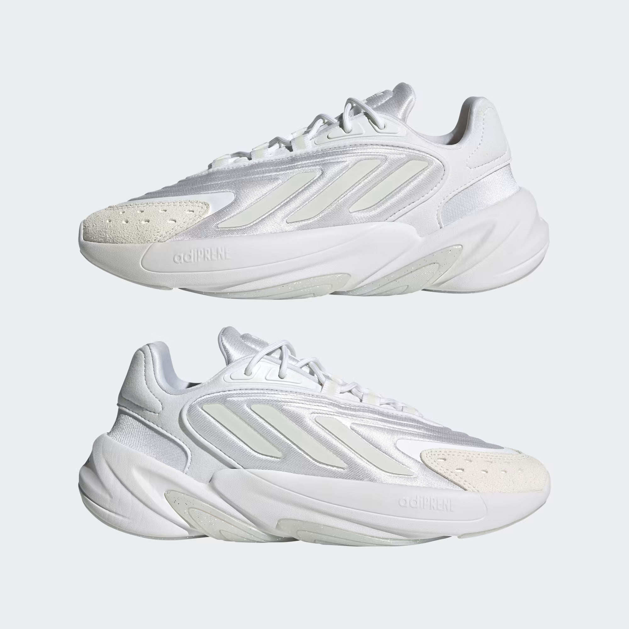 White sneakers with a brand logo on a light gray background