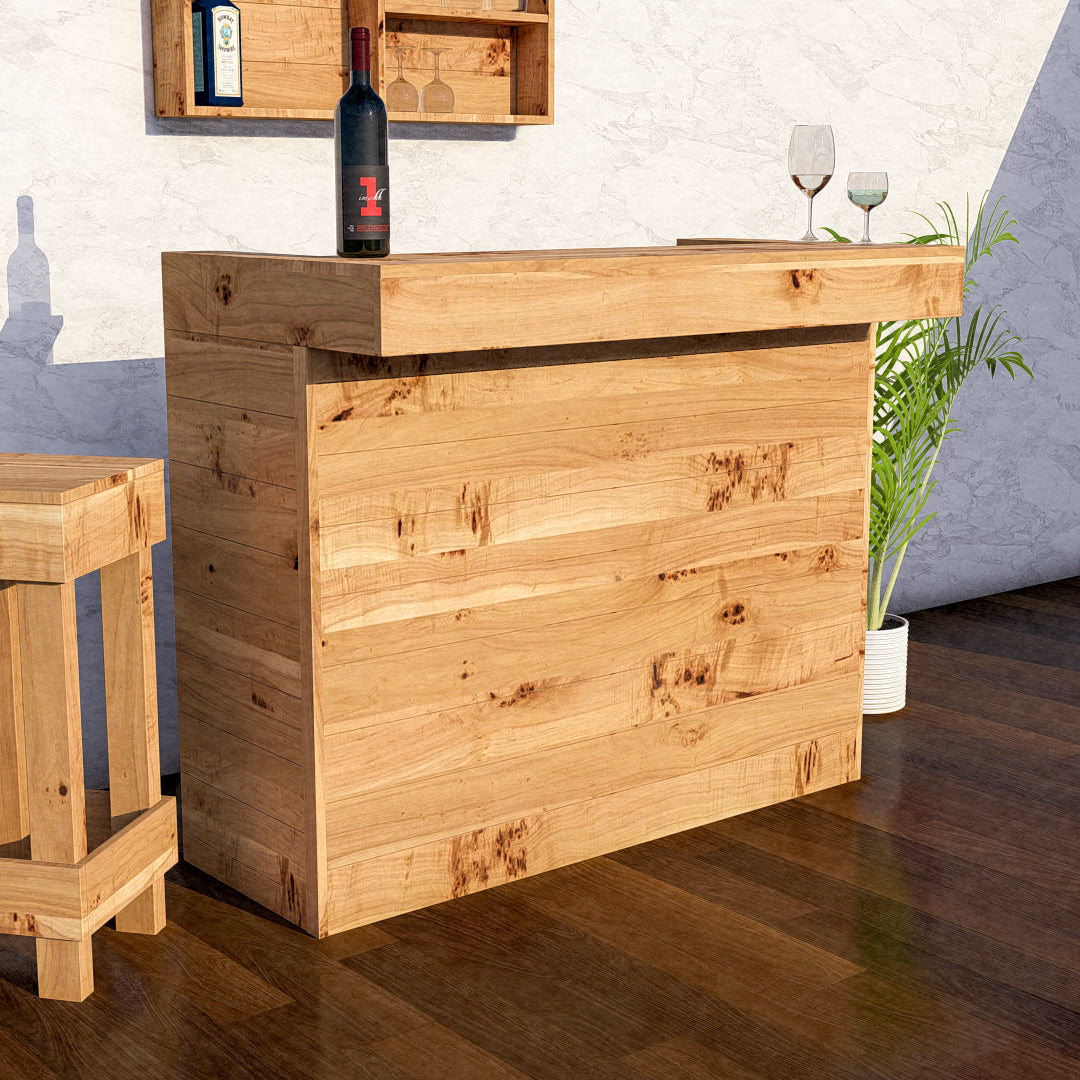 Wooden bar cabinet with a bottle and glasses on top in a home setting