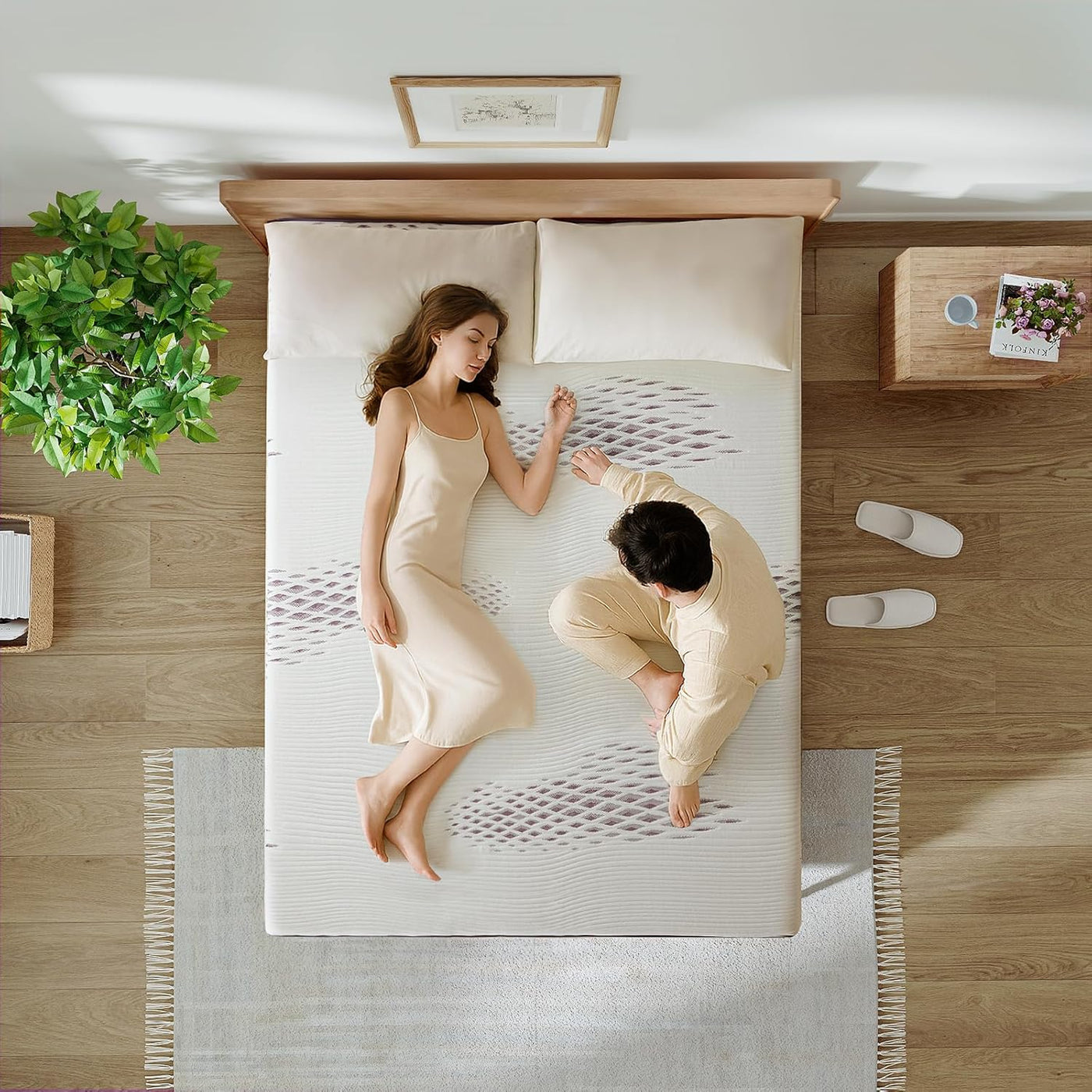 Two people lying on a white mattress in a room with wooden flooring and decor.