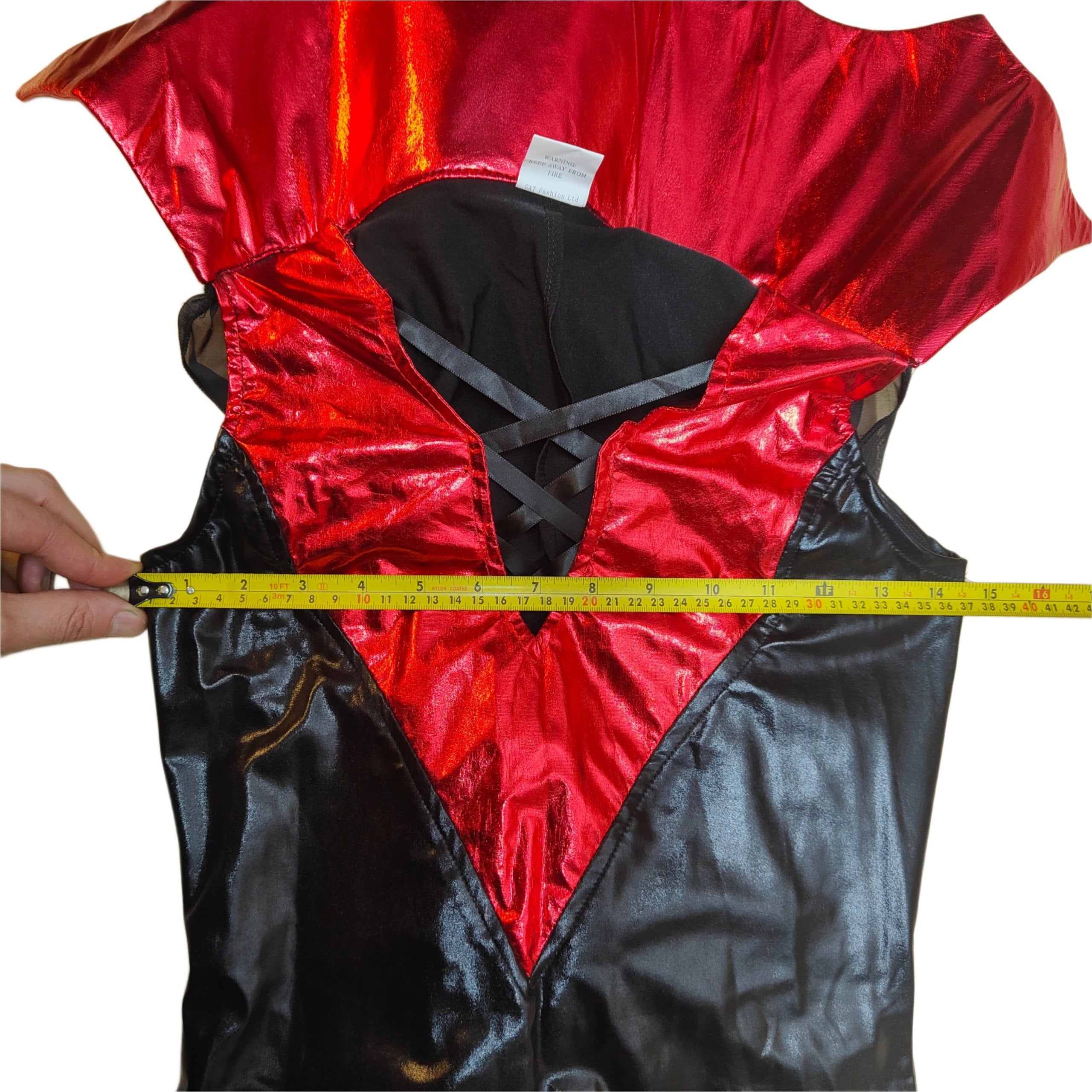 Red and black reflective safety vest being measured with a tape measure on a white background
