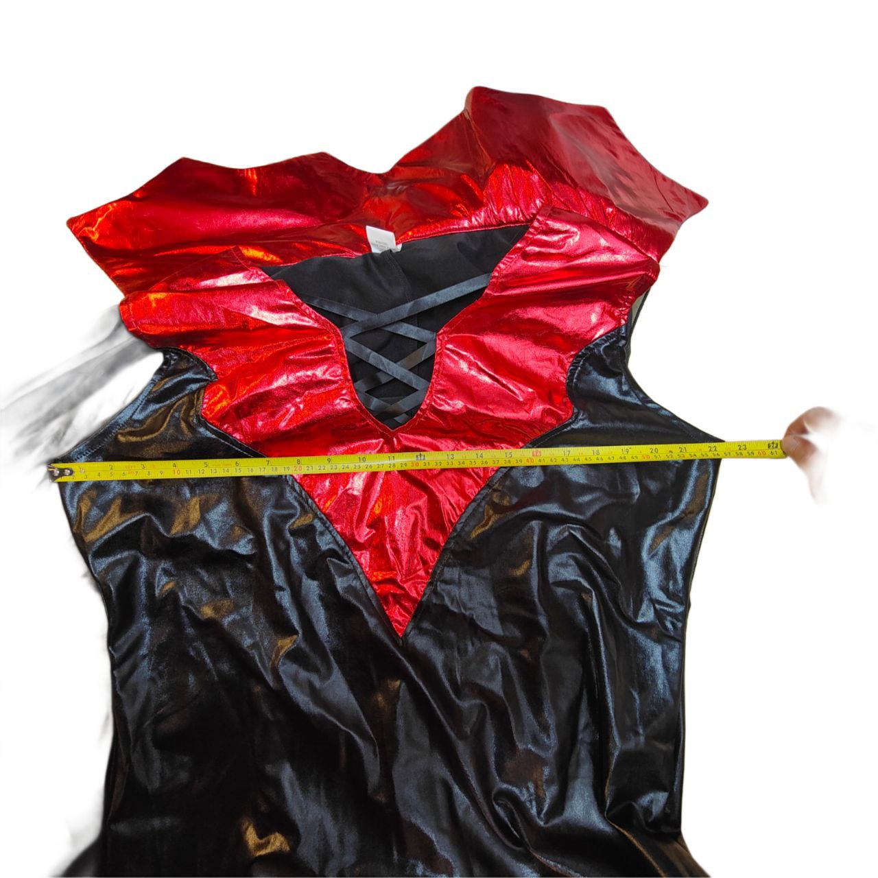 Black and red costume with a measuring tape for size reference on a white background