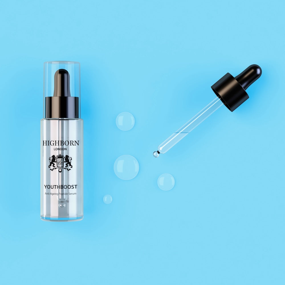 Skincare serum bottle with dropper on a blue background