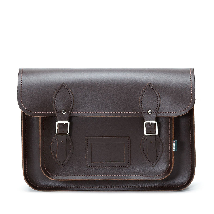 Brown leather satchel with buckle details on a white background