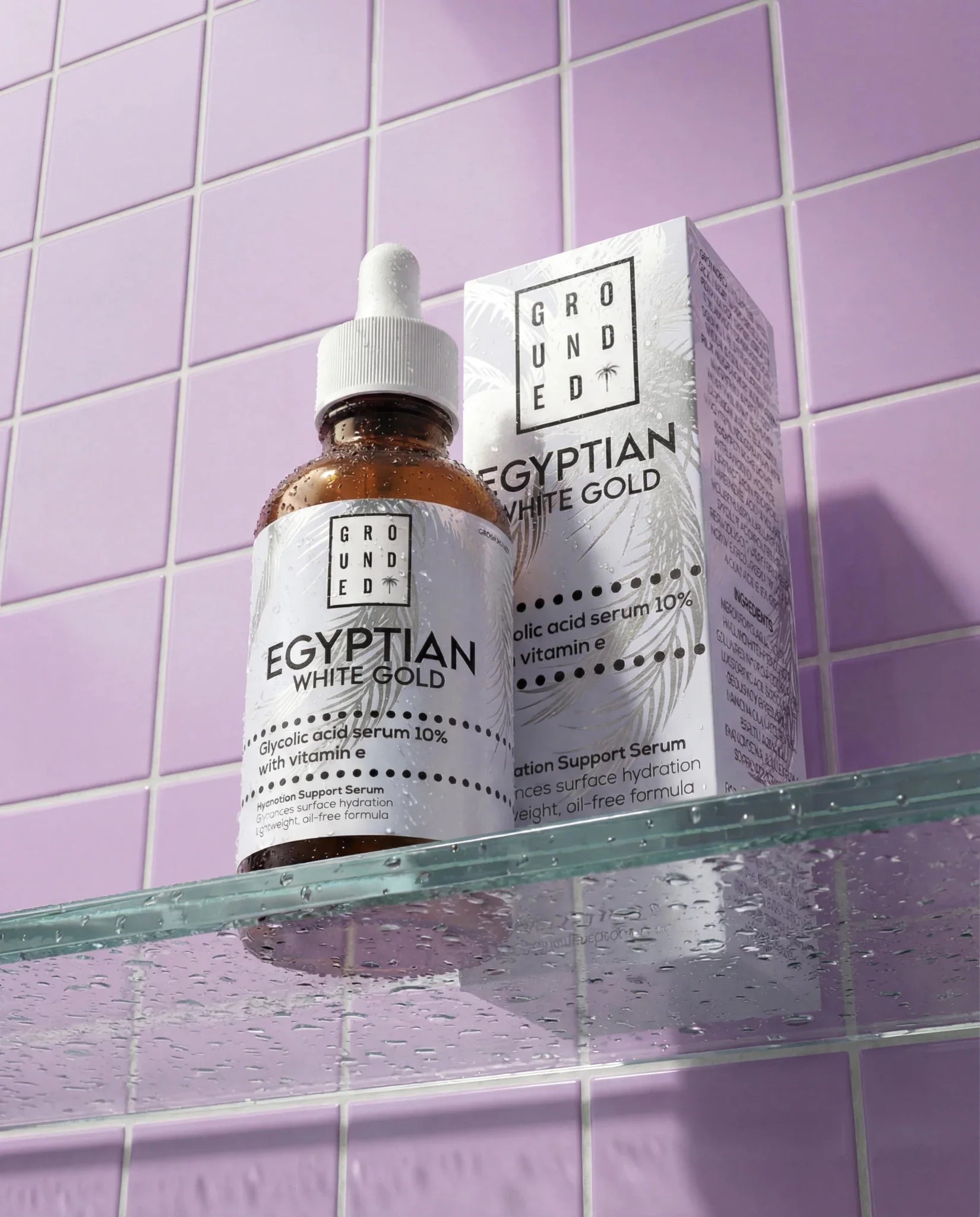 Grounded Egyptian White Gold skincare serum bottle and packaging on a purple tiled shelf.