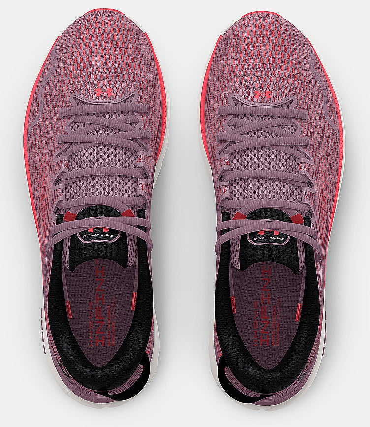 Pair of purple running shoes with red accents on a white background