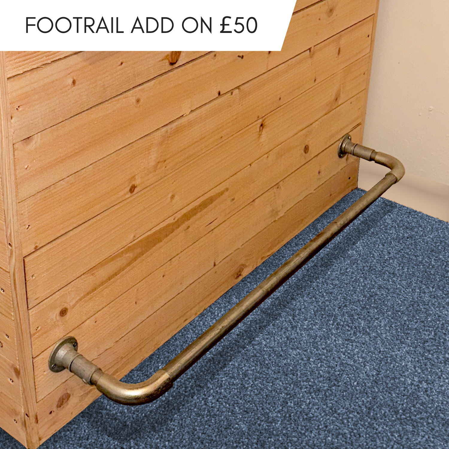 Metal grab bar attached to a wooden wall with text indicating an additional cost of £50.