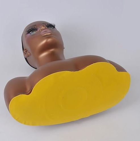 Mannequin bust with a yellow base on a white background
