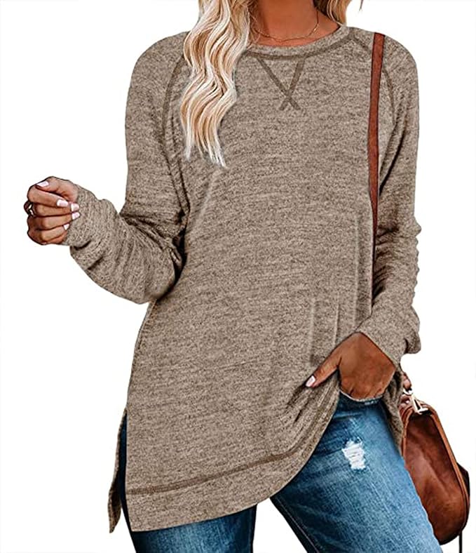 Person wearing a beige long-sleeve top with a brown handbag on a white background