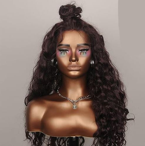 Mannequin head with long, wavy brown hair on a plain background