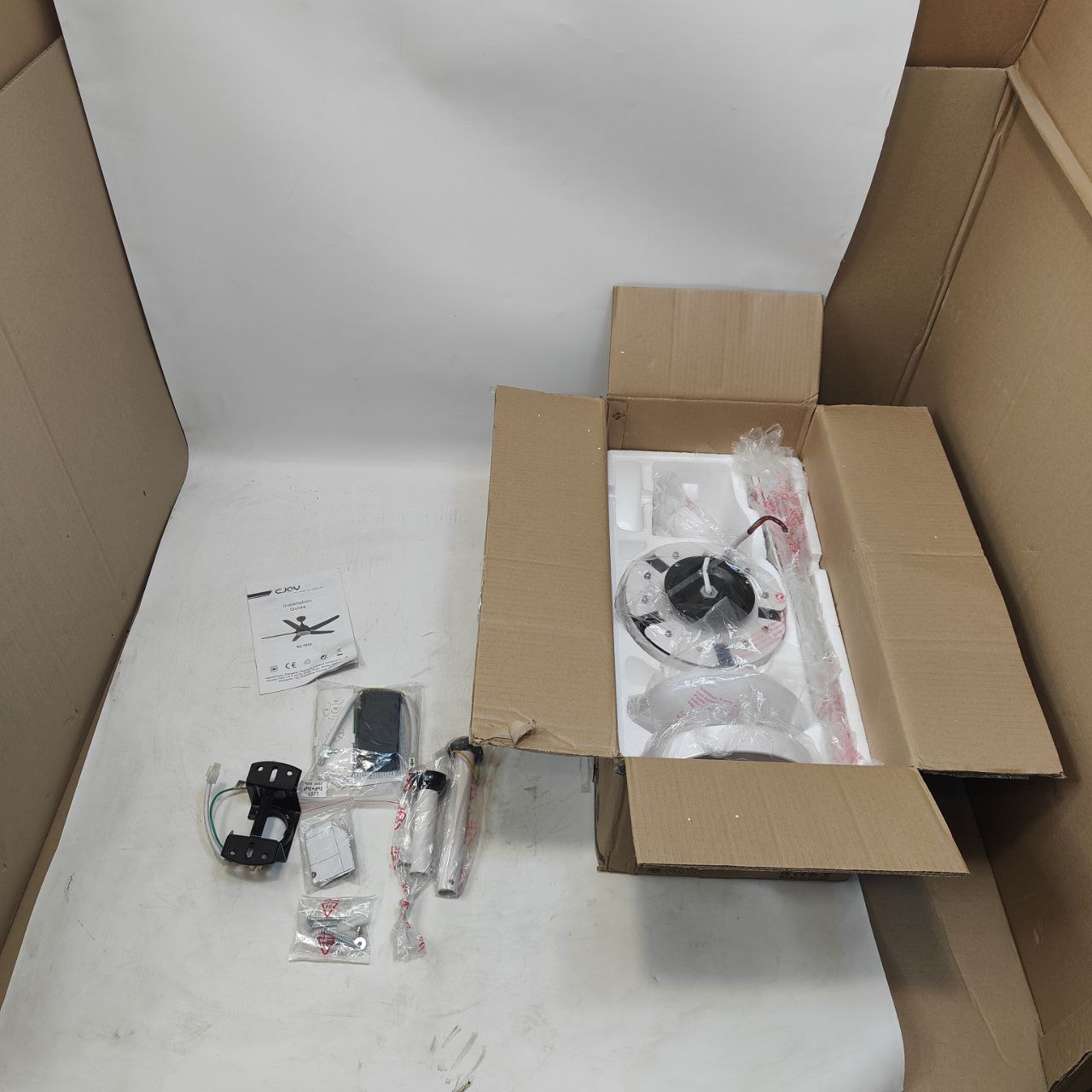 Open cardboard box with electronic components on a white surface