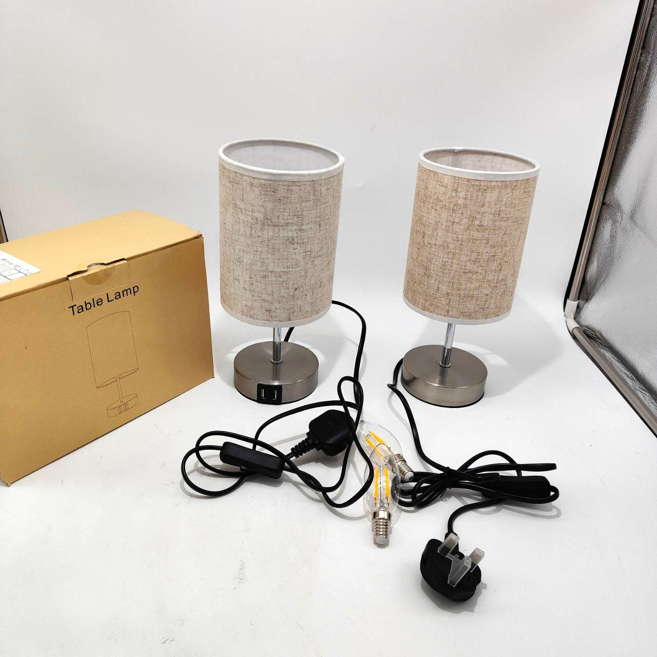 Two table lamps with a cardboard box labeled 'Table Lamp' on a white surface.