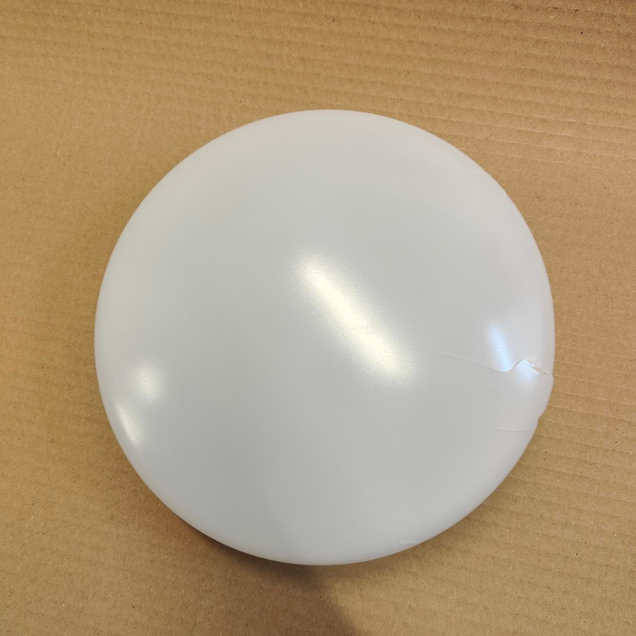 White spherical object on a brown background