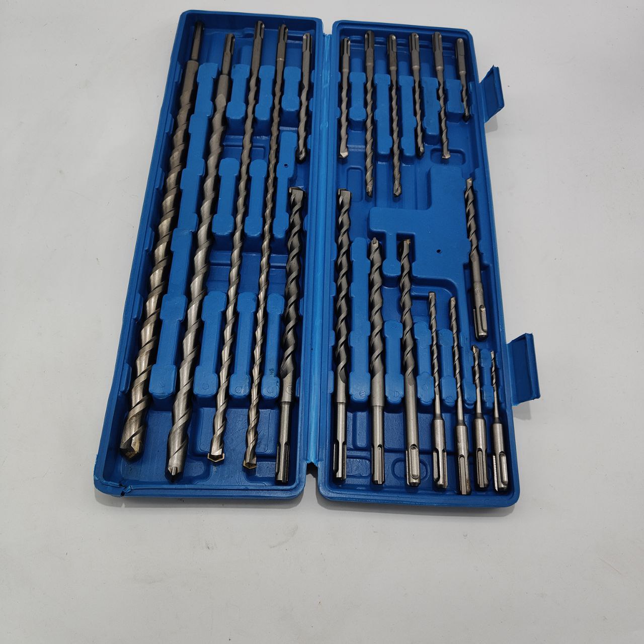 Set of drill bits in a blue case on a white background