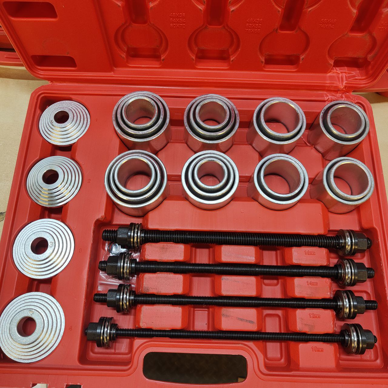 Set of mechanical bearings and tools in a red case