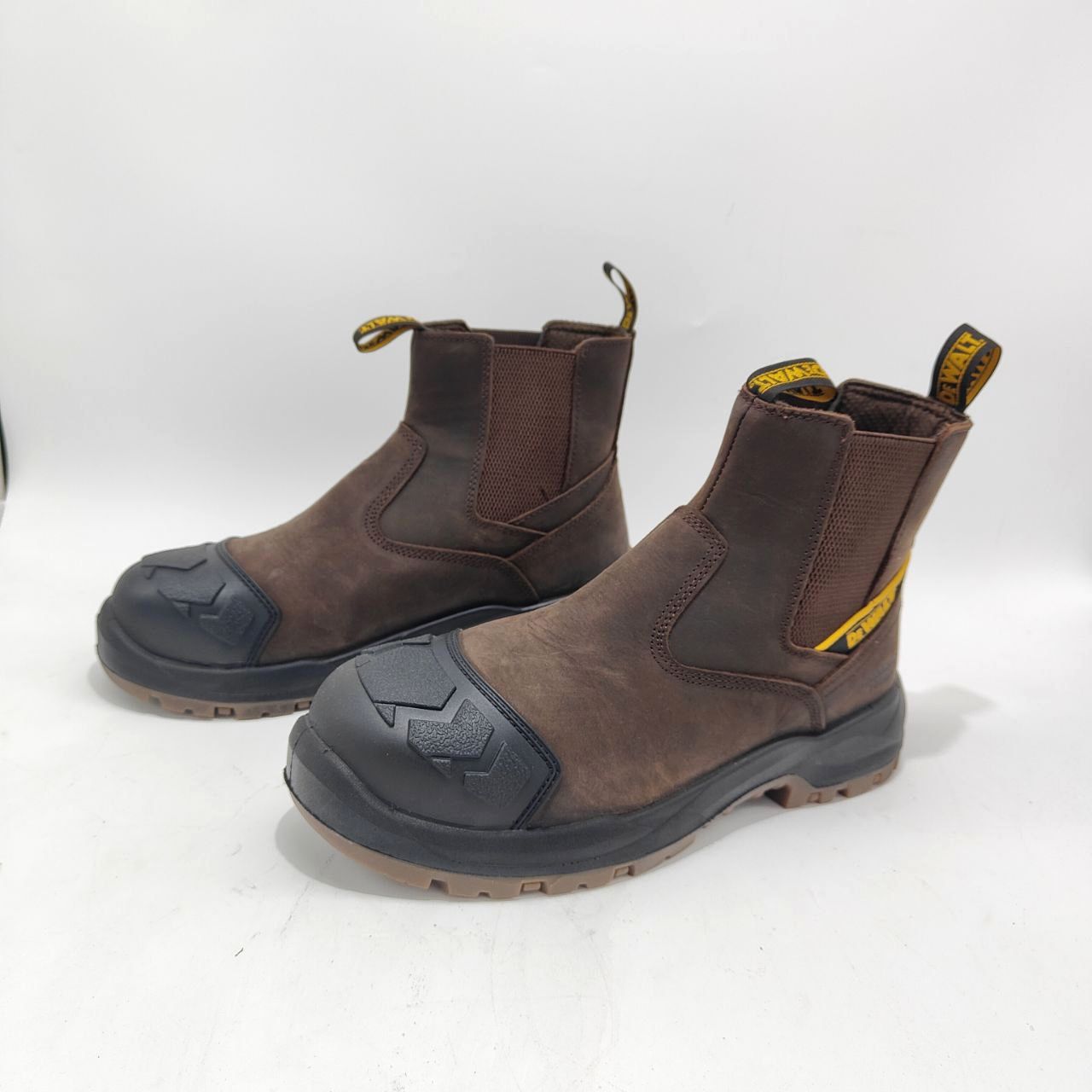 Pair of brown work boots with black soles on a white background