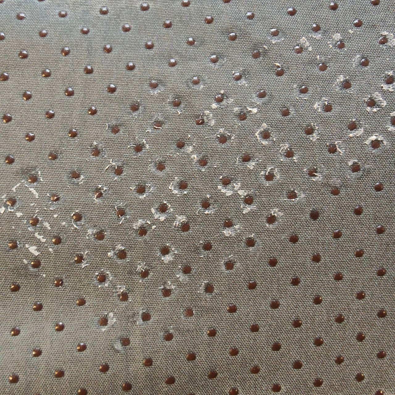 Textured fabric with small brown dots on a gray background