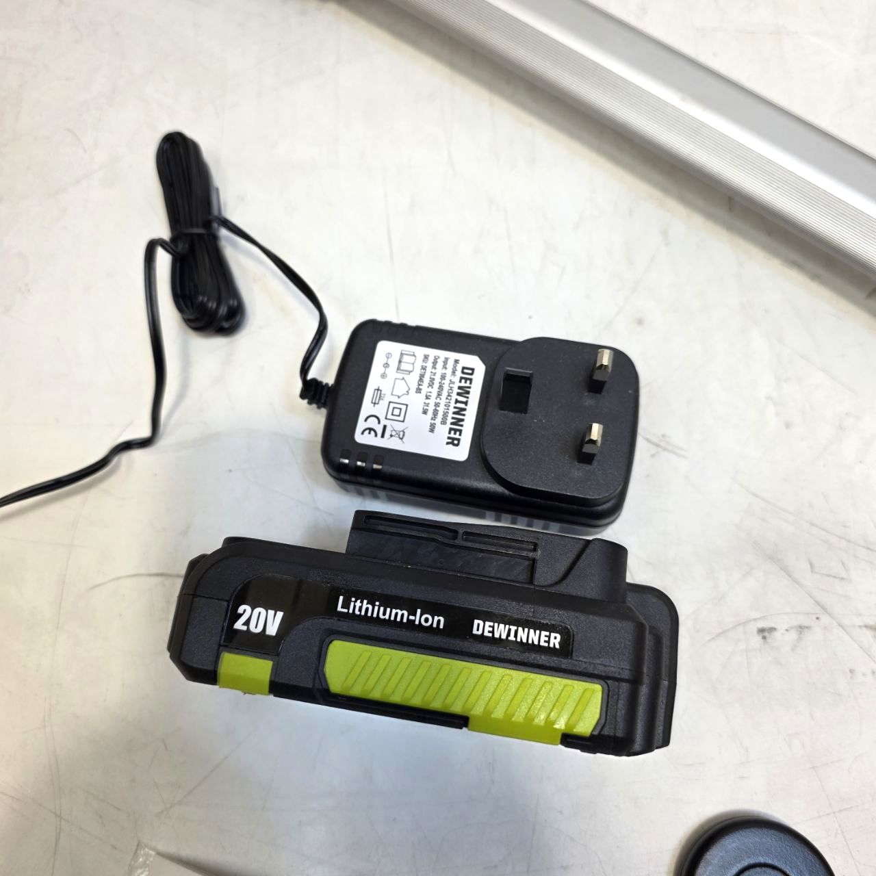 Two DEWINNER lithium-ion batteries on a light-colored surface.