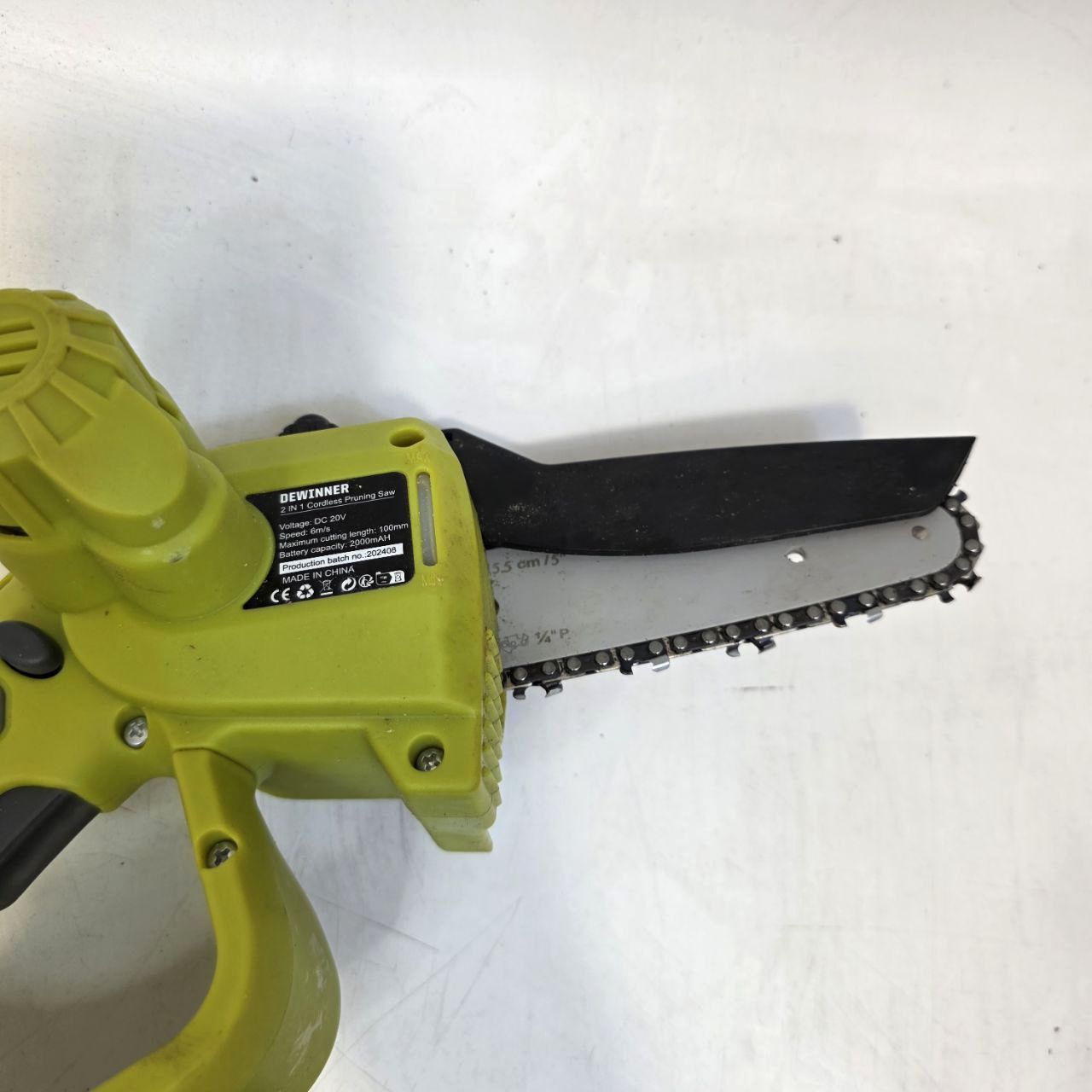 Green chainsaw on a white background