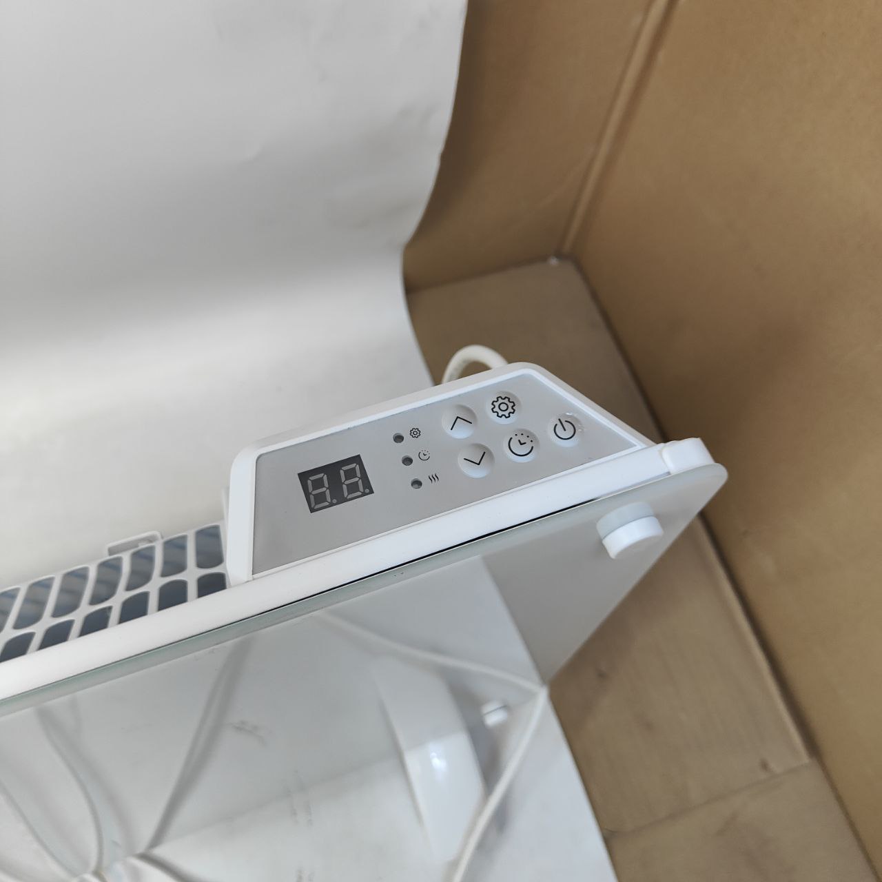 White electronic device with digital display on a white surface