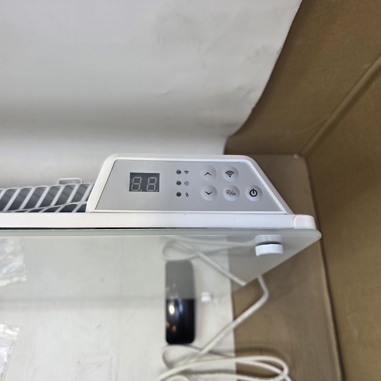 Digital display on a white appliance with a blurred background