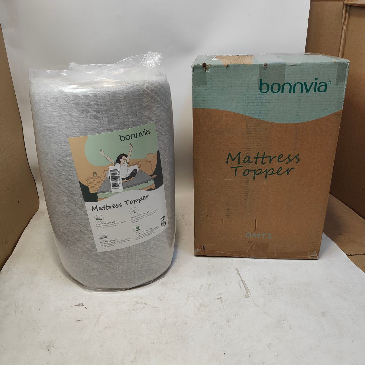 Bonnvia mattress topper packaging including a cardboard box and rolled-up mattress topper on a white surface.