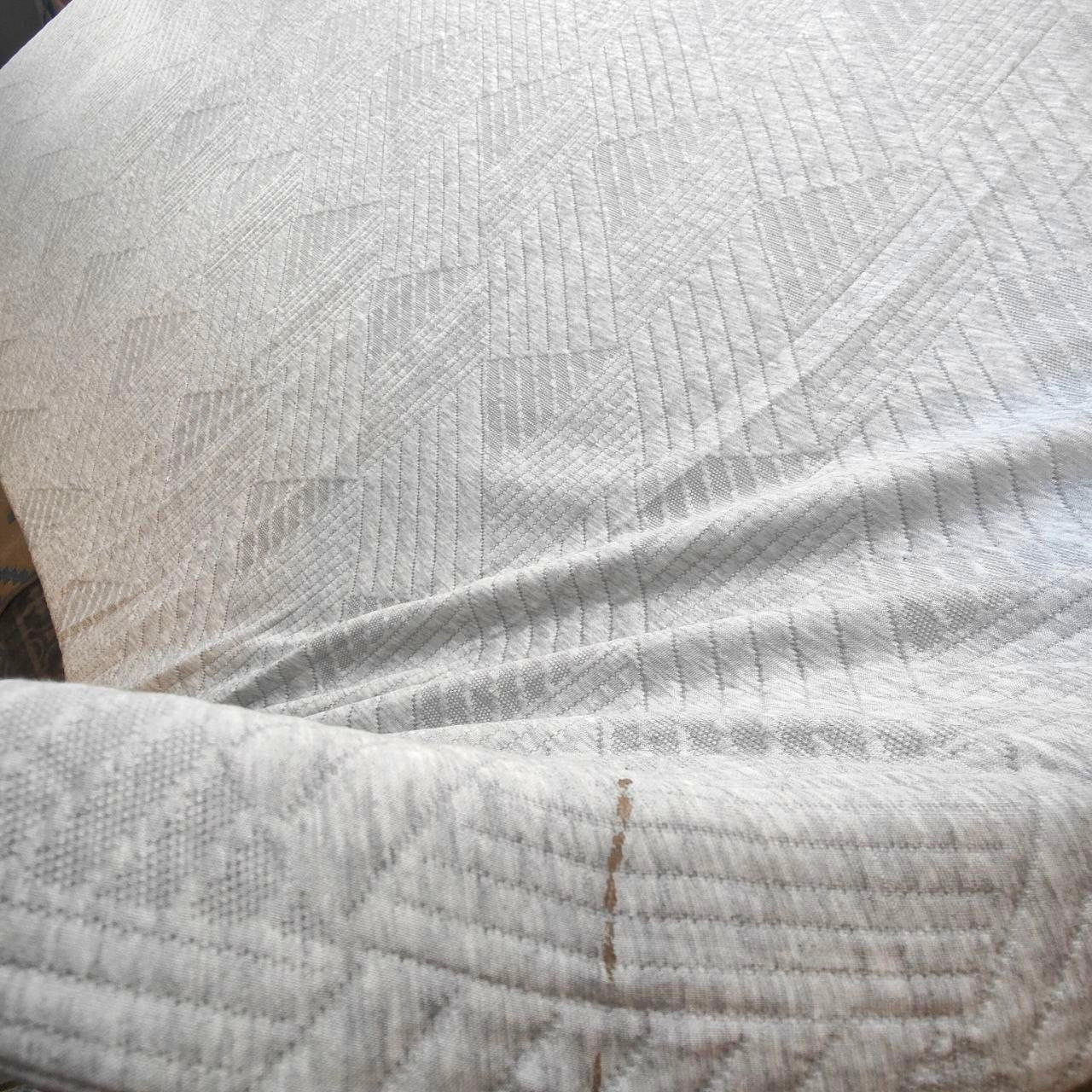 Close-up of textured white fabric with a subtle pattern